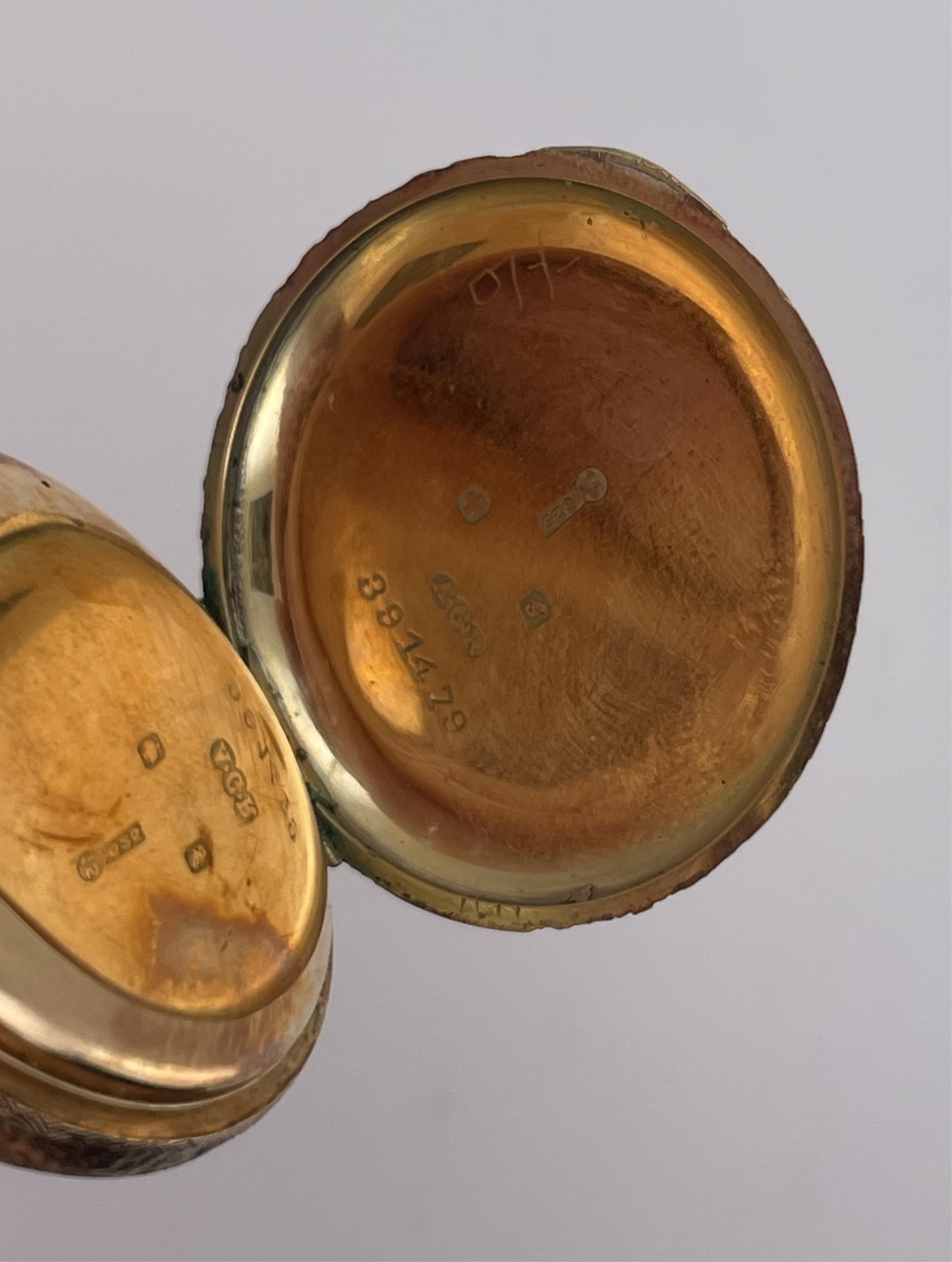 A lady's gold and Swiss enamel fob watch, circa 1907, the cream dial with gold enamel decoration and Arabic numeral indicators, the case with scrolled decoration, the reverse depicting a woman and lamb in a pastoral scen